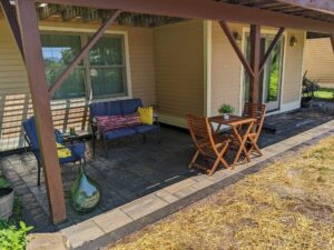 Covered porch with seating and paver patio area by Globe Green, Concord, NH area