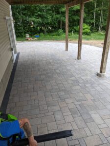 Paver patio under a deck and porch by Globe Green in the Concord, NH area
