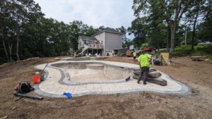 Crew excavating and installing a pool in the Concord, NH area